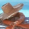 Woman In Swimming Pool In A Large Beige Sunhat